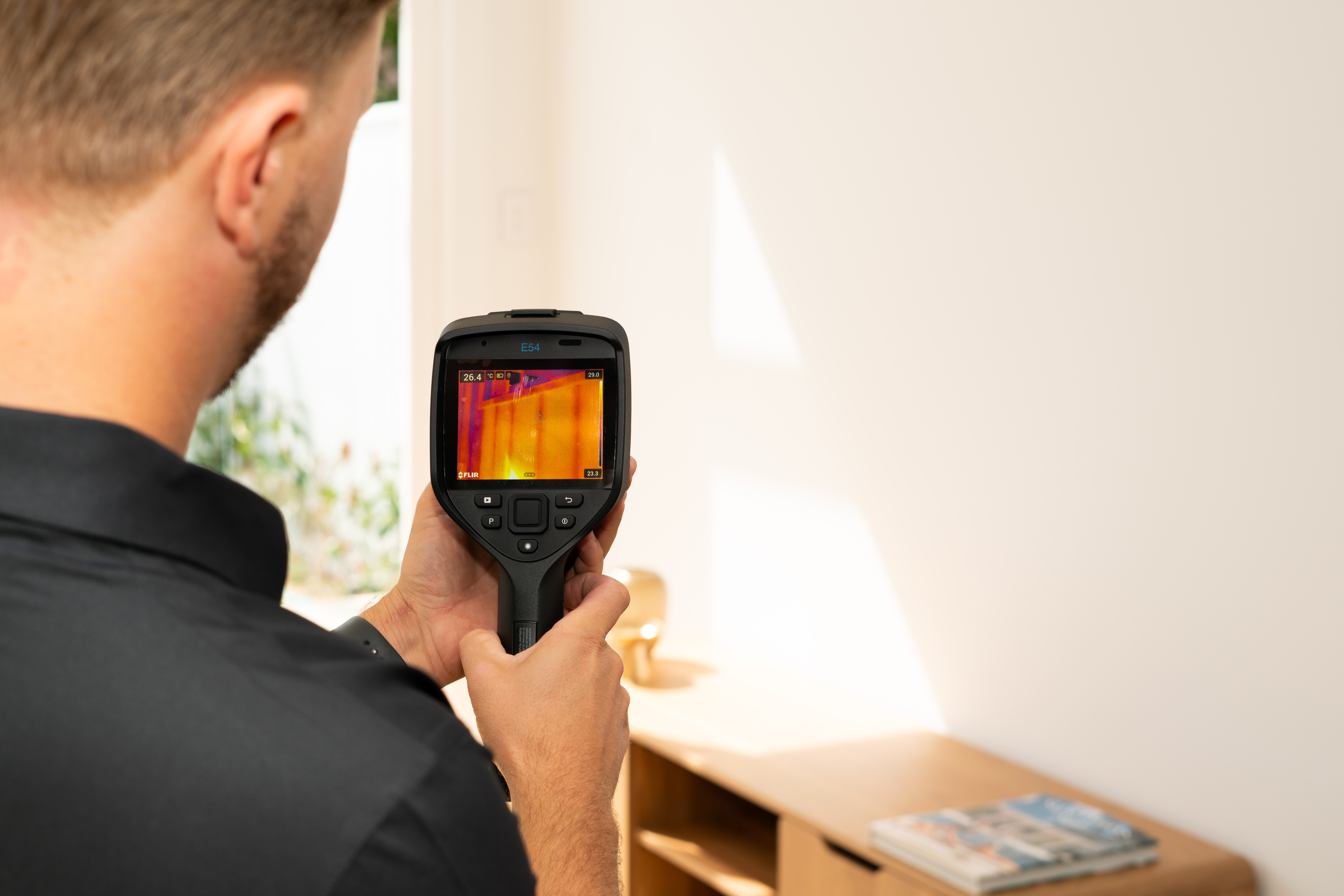 CYTE inspector using a FLIR E54 thermal imaging camera during a Gold Coast building inspection